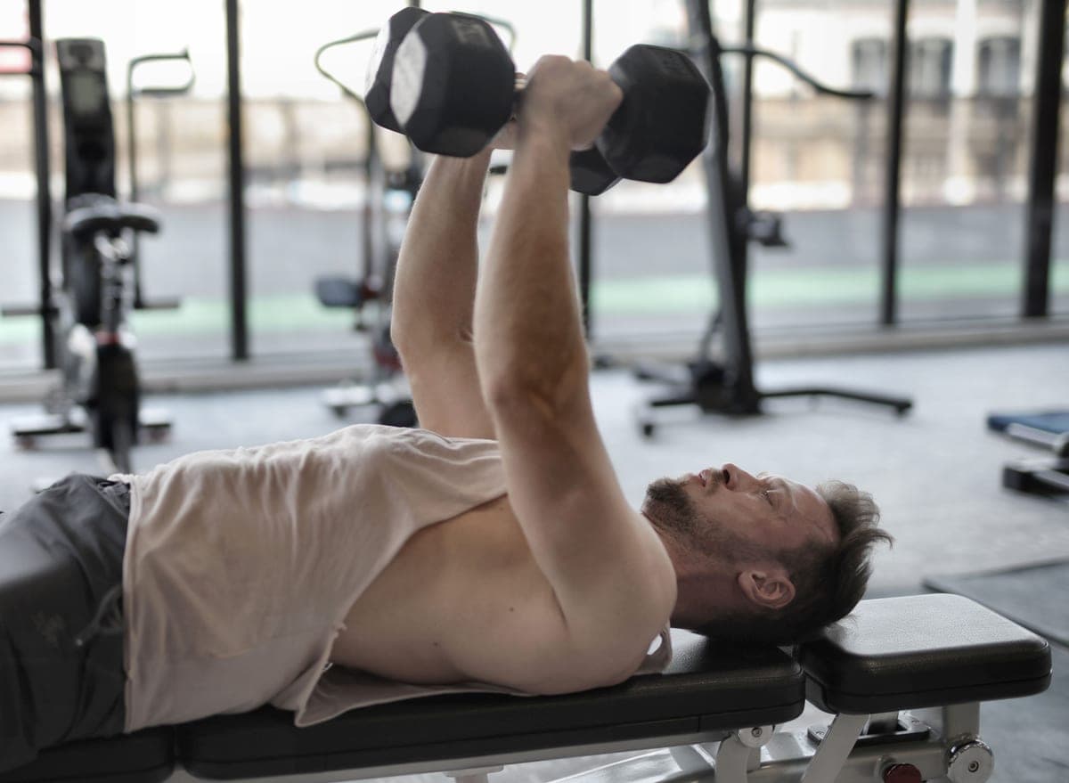 An adjustable weight bench beside a dumbbell rack