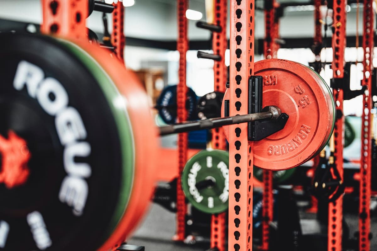 A steel power rack with a barbell in a garage gym